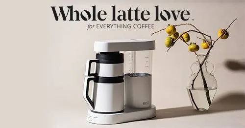 Whole Latte Love - for everything coffee banner. White coffee machine and a vase with flowers.